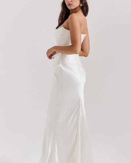 Side view of a white off-shoulder bustier maxi dress, showing the elegant drape and floor-length skirt.