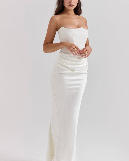 Front view of a white off-shoulder bustier dress, featuring a fitted bodice and gracefully draped skirt detail.