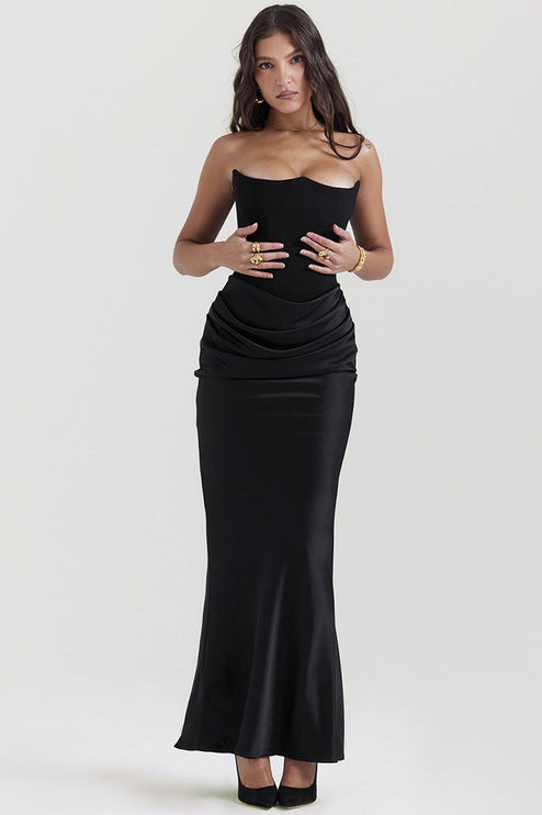 Front view of a black off-shoulder bustier maxi dress, showing the draped satin skirt and fitted bodice.
