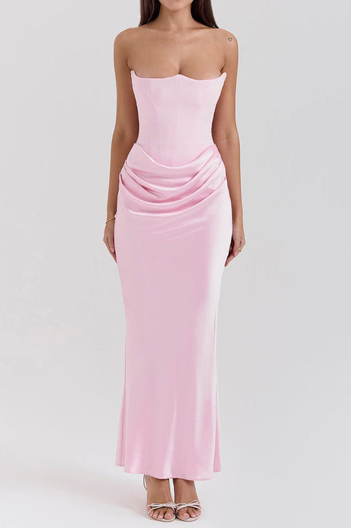 Front view of a women's off-shoulder bustier draped maxi dress in a soft pink, with a structured bodice.