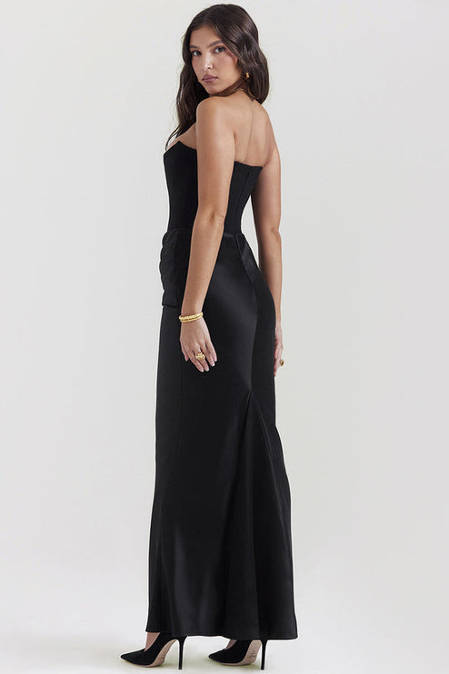 Back view of the black off-shoulder bustier maxi dress, showcasing the smooth satin fabric and floor-length design.