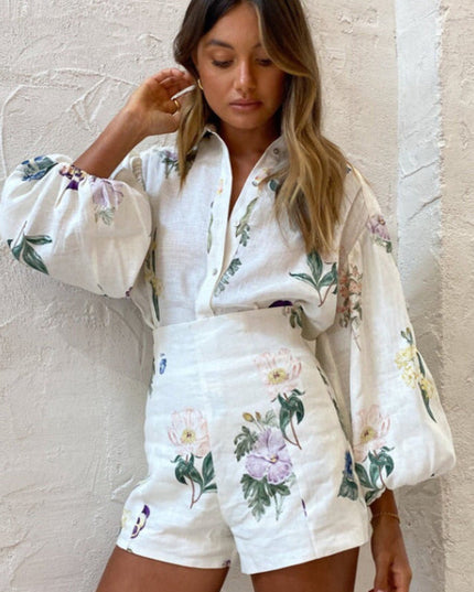 Close-up front view of women's white floral balloon sleeve button-down top and shorts, showing intricate flower details.