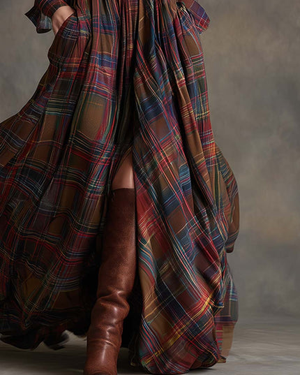 Lower half of a women's flowing multi-color plaid maxi dress, a high slit and brown leather boots.