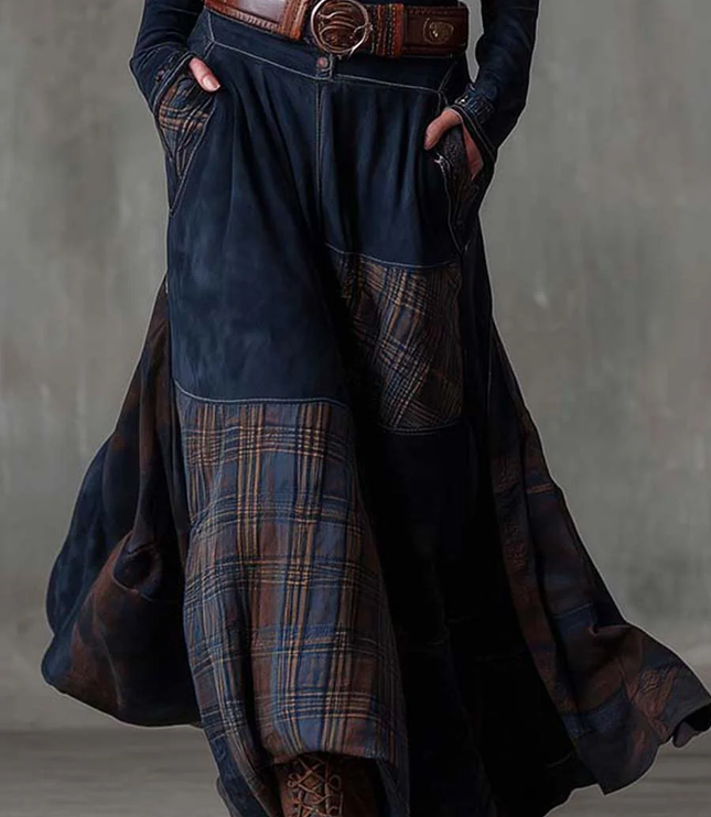 Side view of the dark blue long sleeve plaid maxi dress, highlighting the flowing skirt and earthy plaid pattern.