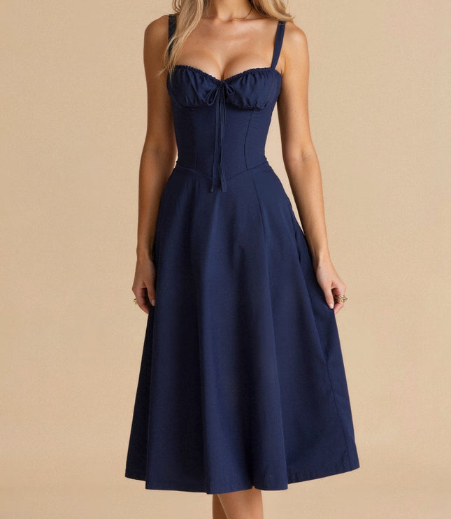 Front view of a navy blue summer midi dress with a structured corset bodice and delicate bow detail.