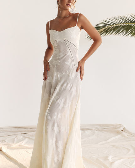 Front view of a white floral corset maxi dress with delicate spaghetti straps and butterfly embroidery.
