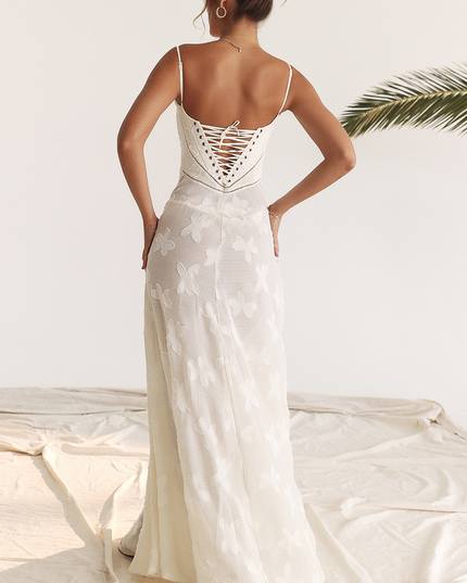Back view of a white floral corset maxi dress featuring a detailed lace-up back and butterfly pattern.