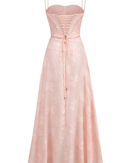 Back flat lay of a light pink floral corset maxi dress, showcasing the full lace-up detail.