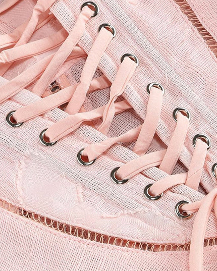 Detail of a pink floral maxi dress showcasing the corset lace-up back with silver eyelets and mesh fabric.
