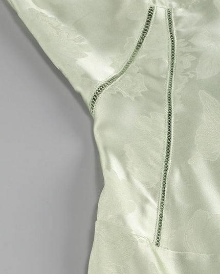 Close-up of the light green floral maxi dress bodice, showing the side panel with decorative stitching.
