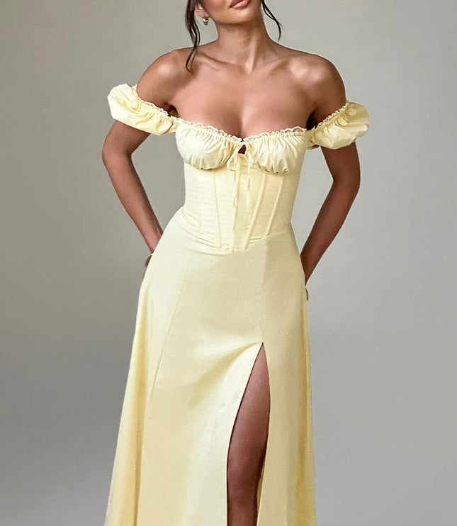 Full-length studio shot of the women's light yellow off-shoulder puff sleeve corset midi dress with a front split.