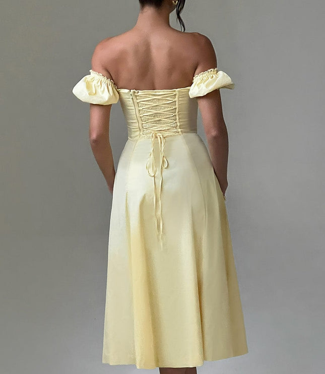 Studio shot, back view of a light yellow off-shoulder puff sleeve midi dress, showing the corset lace-up detail.