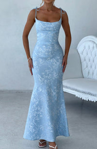 Light blue floral maxi dress for women, featuring delicate spaghetti straps and a mermaid silhouette, for a wedding guest.