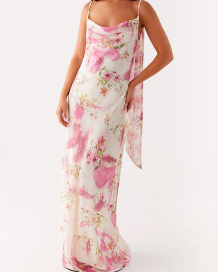 Front view of a women's floral cowl neck maxi dress with pink pattern, showing one arm raised.