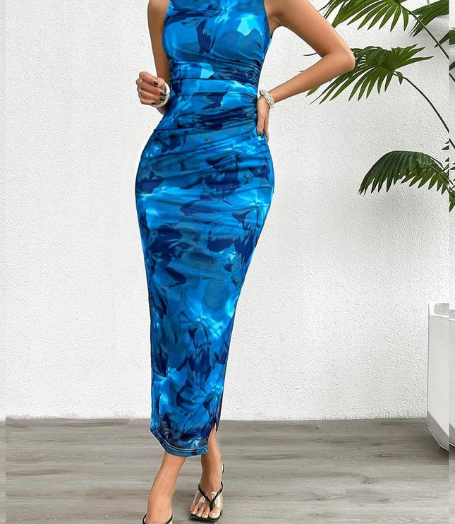 Sleeveless blue gradient print crew neck midi dress with ruched sides and a side slit, styled with black heels.