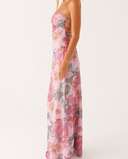 Side profile of a women's pink floral square neck maxi dress, showcasing the long, elegant silhouette.