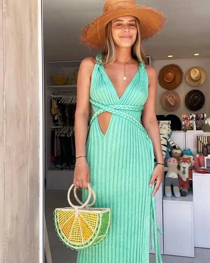 Women's mint green V-neck braided maxi dress with a straw hat and lemon-shaped handbag.