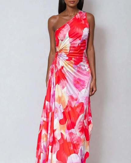 Women's vibrant red and pink floral print one-shoulder maxi dress with a ruched bodice and flowing pleated skirt.
