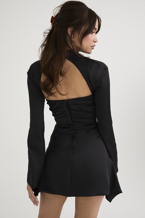 Rear view of the black halter cut out long sleeve mini dress, showing the open back and zipper closure.