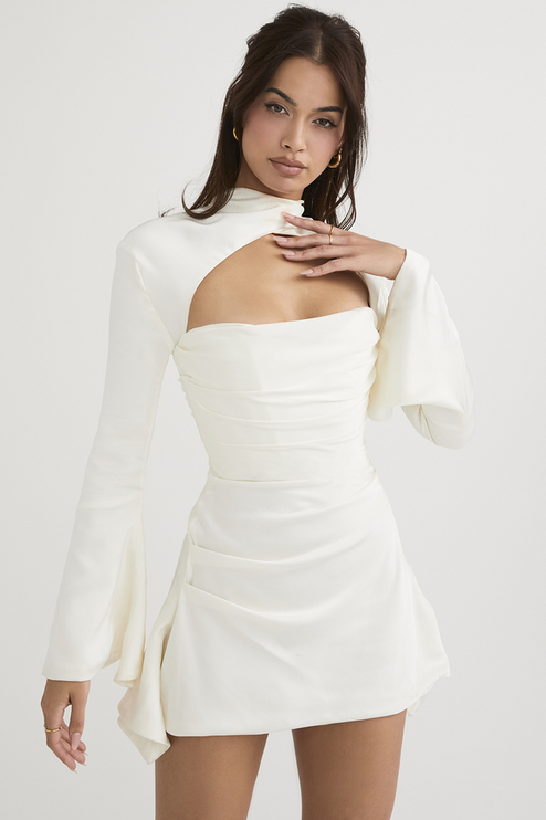 Three-quarter view of the white satin mini dress with halter cut out and bell sleeves, showcasing the dress structure.