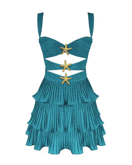Studio shot of a women's shimmery blue summer cut out mini dress with tiered ruffles and gold starfish details.