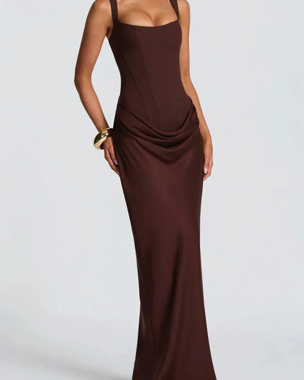 Full-length front view of a women's black square neck draped corset maxi dress, with a subtle side drape.