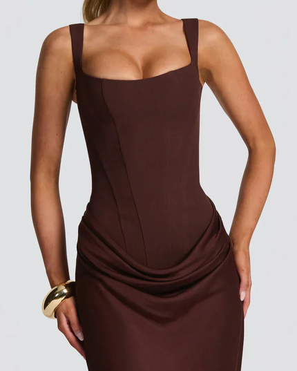 Close-up of the bodice and draped skirt detail of a women's black square neck corset maxi dress.