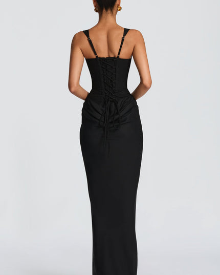 Back view of the black square neck draped corset maxi dress, featuring a detailed lace-up corset back.