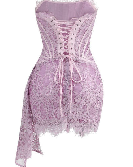 Back view of a light pink strapless lace corset mini dress with a delicate lace-up back and draped lace skirt.