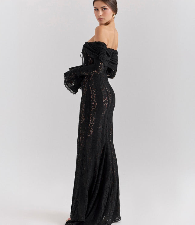 Side profile of a women's black off-shoulder floral lace maxi dress, showing the flowing skirt and long sleeves.