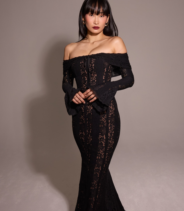Women's black off-shoulder floral lace maxi dress, with the model looking forward, highlighting the dress's design.