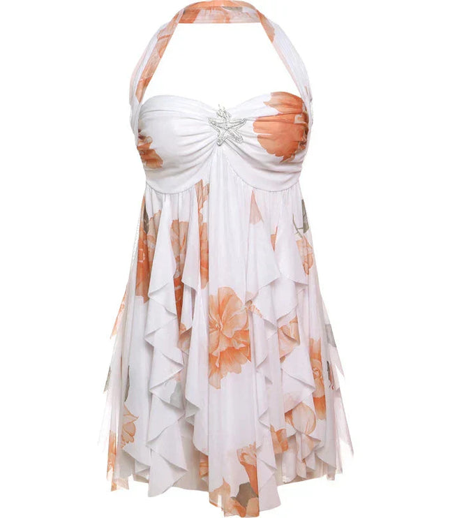 Flat lay of a white halter neck mini dress with orange floral print and ruffled layers.