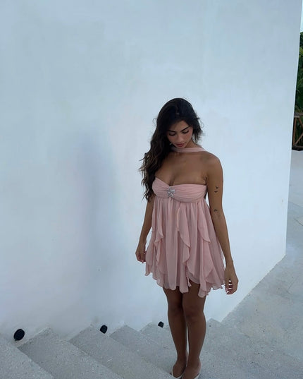 Light pink ruffle mini dress with a halter neck and strapless design, featuring a sparkling front embellishment.