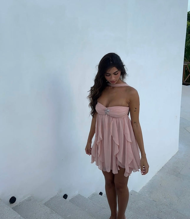 Light pink ruffle mini dress with a halter neck and strapless design, featuring a sparkling front embellishment.