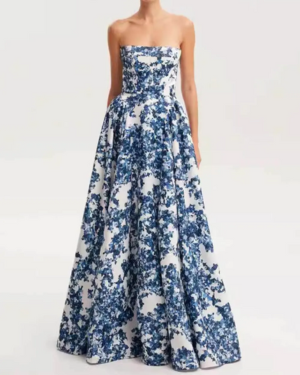 Women's strapless formal maxi dress in a blue floral print, highlighting the elegant silhouette and floor-length design.