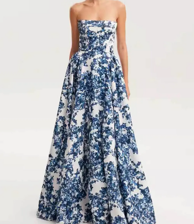 Women's strapless formal maxi dress in a blue floral print, highlighting the elegant silhouette and floor-length design.
