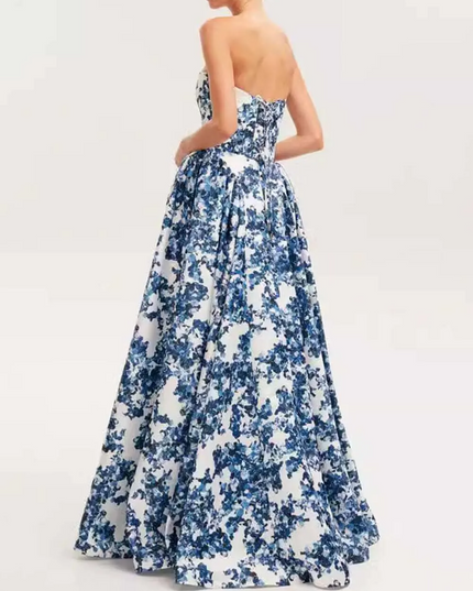 Back view of a women's blue and white floral strapless formal maxi dress, showing the full voluminous skirt and fitted back.