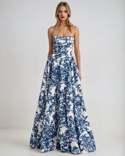 Full length view of a women's strapless formal maxi dress with a blue and white floral print, featuring a full A-line skirt.