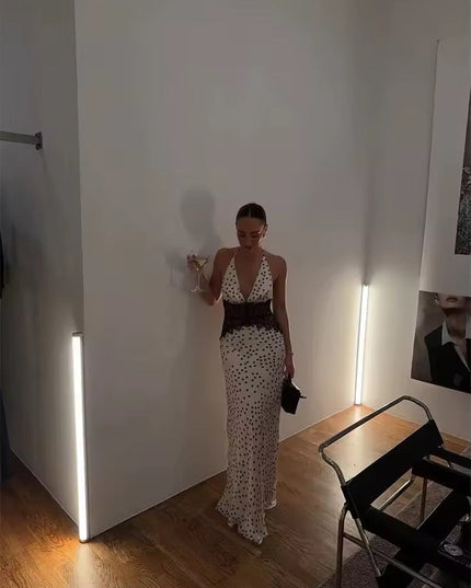 Full length shot of the women's polka dot halter neck lace maxi dress, featuring the deep V-neck and black lace waist.