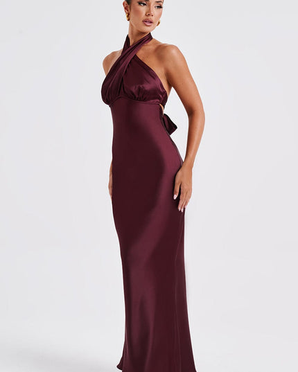 Side profile of the women's burgundy formal maxi dress, highlighting the halter neckline and body-skimming fit.