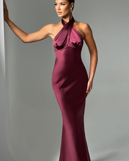 Elegant women's formal halter neck maxi dress in a rich burgundy color, featuring a fitted bodice and flowing skirt.