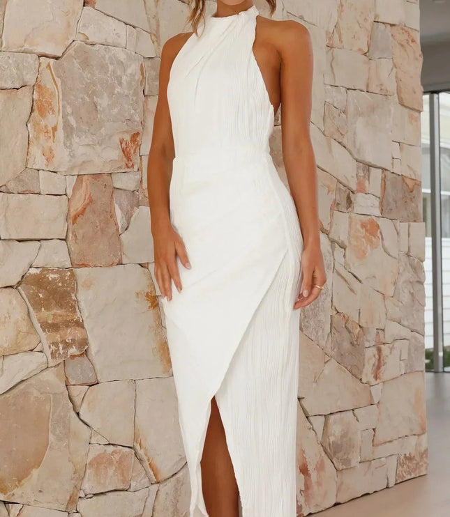 Full view of a white summer halter neck pleated maxi dress featuring a chic side slit and textured fabric.