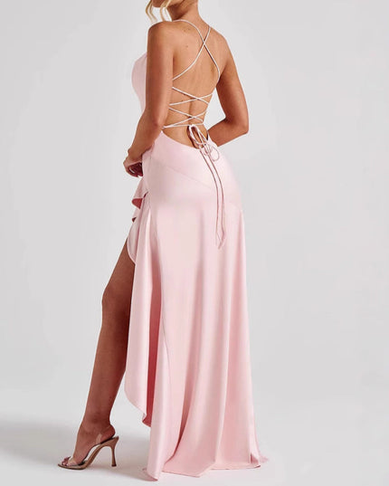 Back view of a light pink high low maxi dress with a criss-cross lace-up back and ruffled detail.