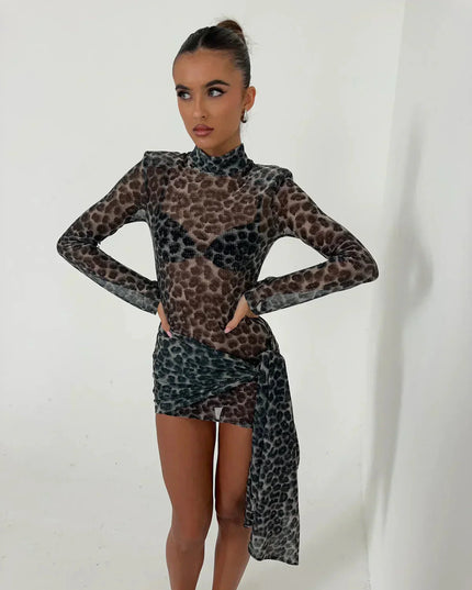 Front view of women's dark leopard print high neck ruched mini dress with long sleeves, hands on hips.