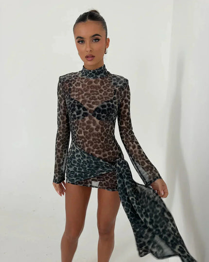 Close up front view of women's dark leopard print high neck ruched mini dress, sheer fabric and detailing.