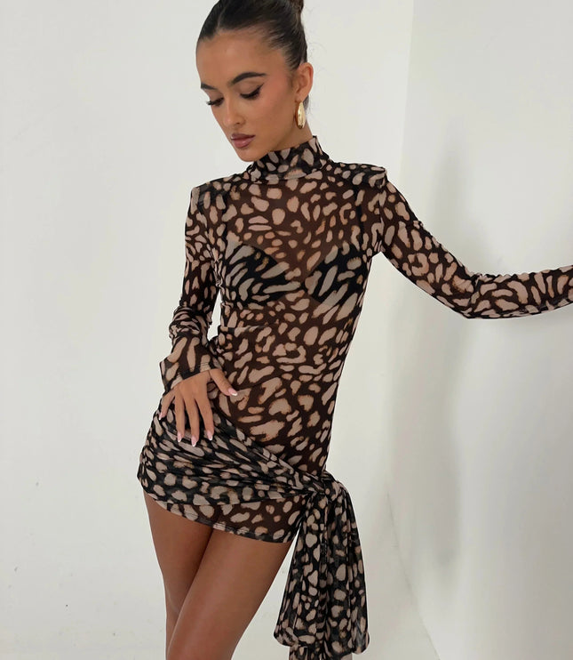 Women's leopard print high neck ruched mini dress with long sleeves and cascading fabric detail, side view.