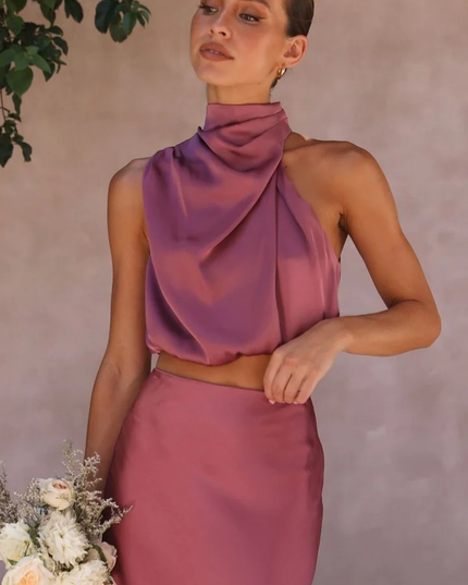 Close-up of the plum satin asymmetrical high neck crop top, part of a wedding guest maxi set.