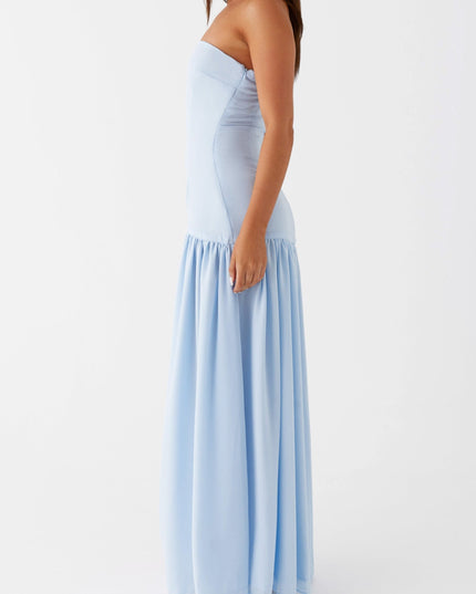 Side profile of a light blue strapless maxi dress, highlighting the tailored fit and long skirt.