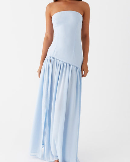 Angled front view of the light blue strapless maxi dress, featuring a subtle side slit and gathered skirt.