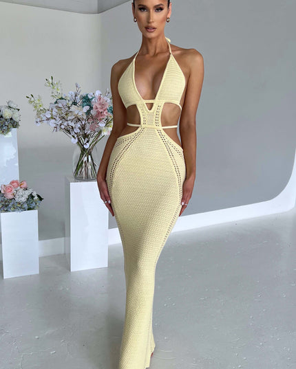 Front view of a women wearing a light yellow crochet knit plunge halter maxi dress, featuring a fitted silhouette and cut-out details.
